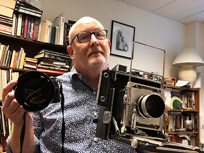 Self portrait of me with an old camera and a new one
